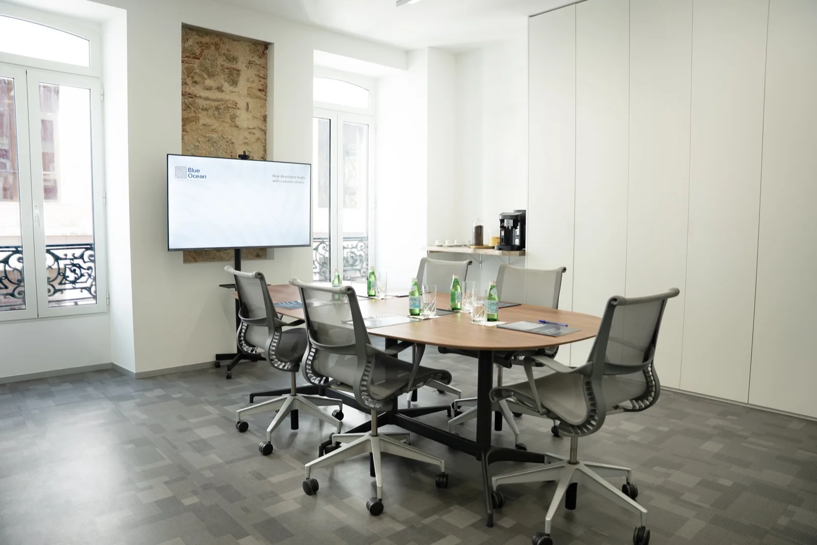 Blue Ocean Immigration meeting room in Lisbon — boardroom with branded screen and Avenida da Liberdade balcony